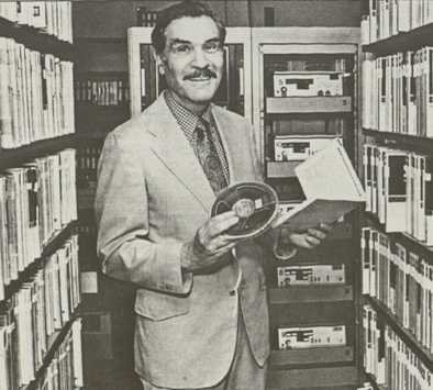 Dr. Maurice Crane holding a 1/4 inch audio reel