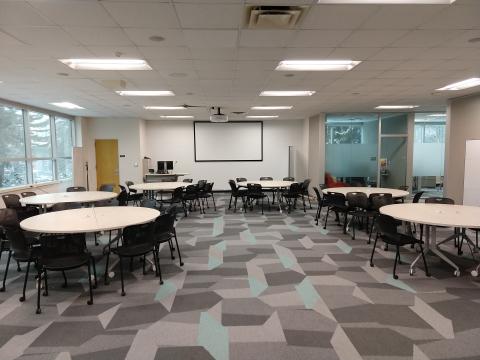 The Digital Scholarship Lab Flex Space with round tables and chairs